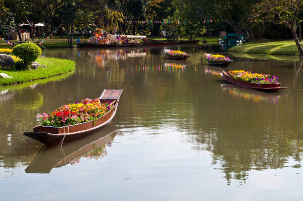 Flower boat in canal at public park, Thailand.
