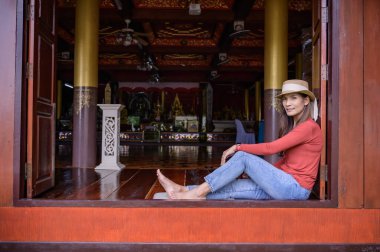 Asian woman with old building background at Phayao province, Thailand.