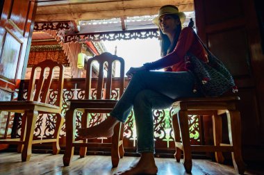 Asian woman with old building background at Phayao province, Thailand.