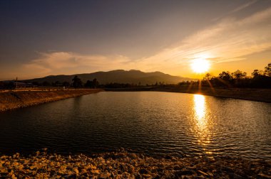 Reservoir with mountain view at sunset, Chiang Mai province.
