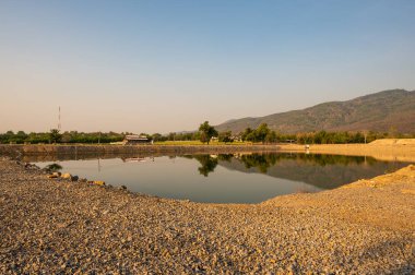 Reservoir with mountain view at evening, Chiang Mai province.