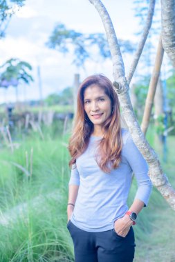 Asian Woman in Park at Phayao Province, Thailand.