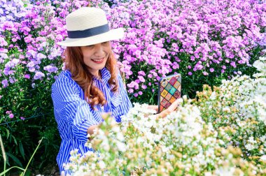 Thai Woman with Beautiful Flower Garden at Chiang Mai Province, THailand.