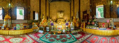 CHIANG RAI, THAILAND - July 18, 2020 : Panorama View of Ancient Buddha Statue at Wat Phrathat Pha Ngao, Chiang Rai Province.