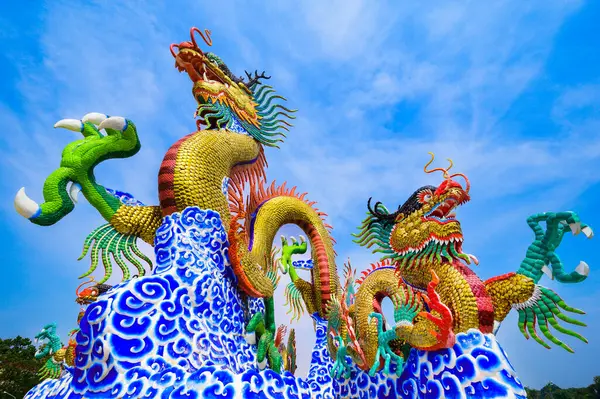 Mavi gökyüzü ile altın ejderha heykeli, Nakhon Sawan vilayeti..