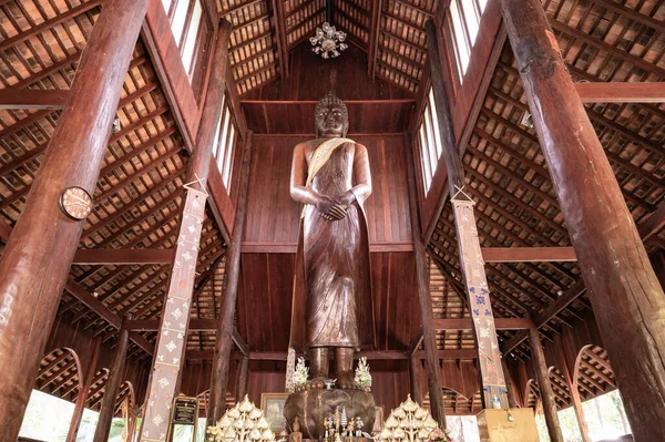 CHIANG MAI, THAILAND - March 19, 2022 : The Wooden Standing Buddha of Wat Luang Khun Win in Chiangmai Province, Thailand.