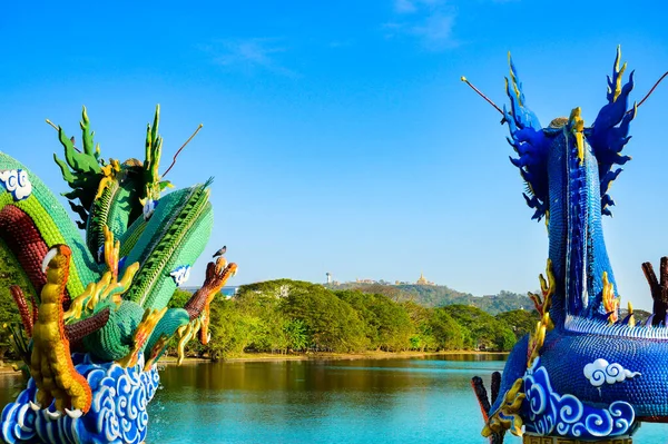Green dragon statue and blue dragon statue with lake view at Nakhon Sawan Province, Thailand.