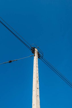 Electrical pole with wire on blue sky, Thailand