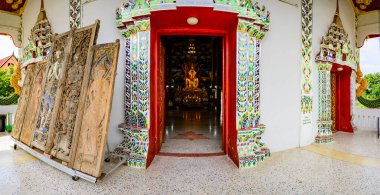 NAN, THAILAND - November 5, 2020 :  Panorama View of Old Buddha Statue with Thai Style Church in Prang Temple, Nan Province.