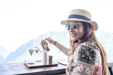A female tourist making drip coffee at Pha Hi village, Chiang Rai Province.