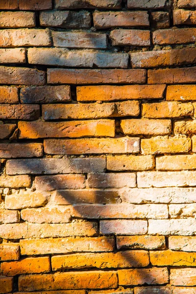 Old brick wall with black shadow, Thailand.