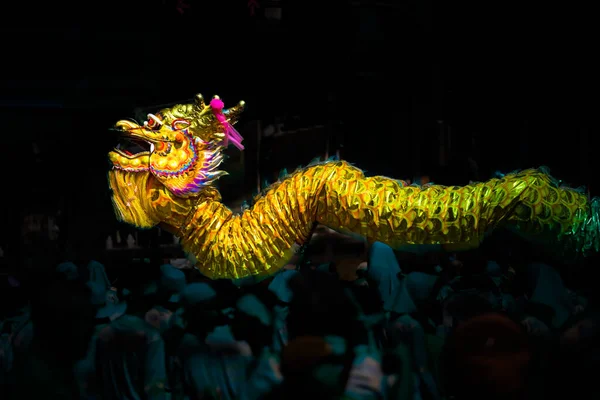 Chinese dragon dance with dark background during Chinese New Year festival.