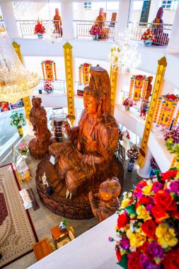 Guan Yin statue made from wood in Hyuaplakang temple, Thailand. clipart