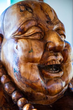 Phra sangkatchai monk statue made from wood in Hyuaplakang temple, Thailand. clipart