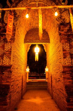 Night scene of Lanna style arch at Lok Molee temple, Chiang Mai province.