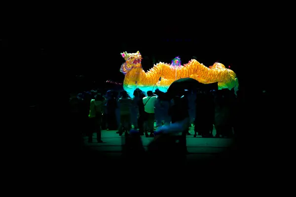 Chinese dragon dance with dark background at Nakhon Sawan Province, Thailand.