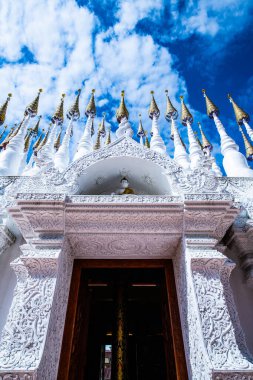 The Pong Sunan temple with clouds in Phrae province, Thailand. clipart