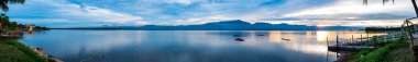 PHAYAO, THAILAND - July 21, 2020 : Panorama View of Kwan Phayao Lake at evening, Thailand.
