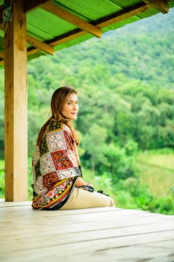 Asian Woman in Thai Native Pavilion with Rice Field Background at Pa Bong Piang Rice Terraces, Chiangmai Province.
