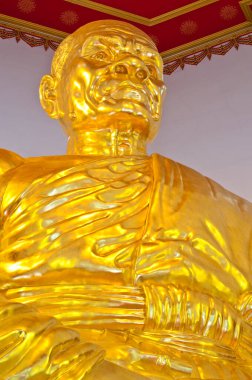 Tayland 'daki Tayland tapınağında altın keşiş heykeli.