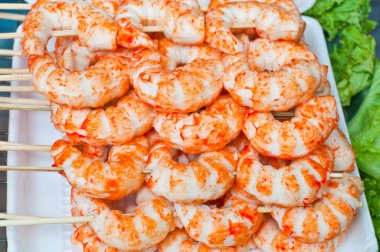 Tabağında şiş olan kırmızı karides..