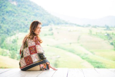 Asian Woman in Thai Native Pavilion with Rice Field Background at Pa Bong Piang Rice Terraces, Chiangmai Province.