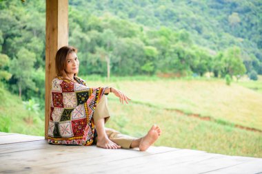 Asian Woman in Thai Native Pavilion with Rice Field Background at Pa Bong Piang Rice Terraces, Chiangmai Province.