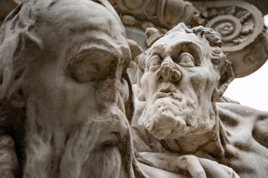 Marble heads on a monument in Rome, by Pascal Kehl