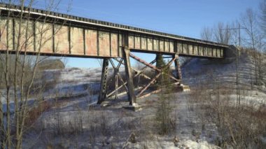 Railway bridge over frozen river in Northern Ontario.