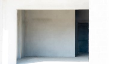 Newly built house walls plastered with cement. but not yet painted. Background image of house construction.