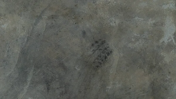 Background and textured above view of cement floor gray color. Cement surface with faint tire marks. Surface of cement floor indoor.
