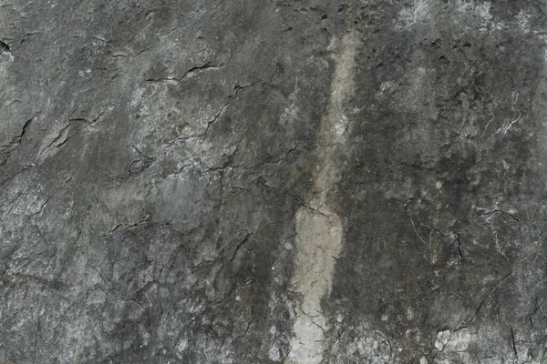 Taş zemin eşsiz pürüzlü bir yüzeye ve koyu renge sahiptir. Arkaplan ve doku için.