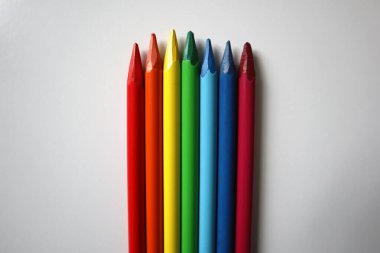 Photo of colored pencils on a white background. Arranged in a color gradient in the colors of the rainbow. Pencils of different lengths. Located vertically. They do not have wood. Sharpened. LGBT clipart