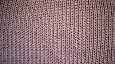 Doku arka planı. Mor örgü kumaş. Makro fotoğraf. Farklı tonlar. Kalın giysiler. Süveter, atkı, battaniye. Hobi, el yapımı. Samimi.