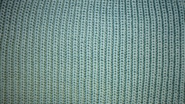 Arka plan nane yeşili örülmüş kumaş dokusuyla dolu. Makro fotoğraf. Dikey çizgiler. Şablon. Geçmişi. Turkuaz.