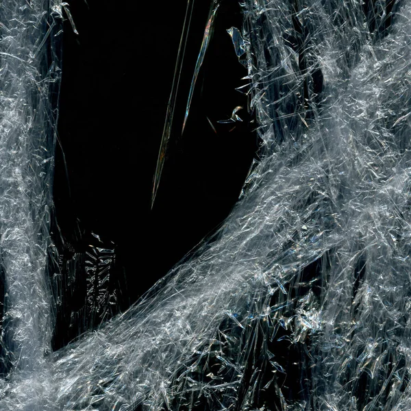 Wrinkled plastic wrap texture on a black background wallpaper. Royalty high-quality free stock photo image of realistic plastic wrap for overlay, copy space, and photo effect. Wrinkled plastic surface