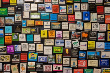 Invercargill, South Island, New Zealand- January, 2023: Vintage matchbook collection on the black background in Bill Richardson Transport World Museum
