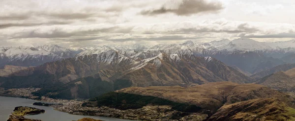 stock image Gaze over the Southern Alps and an aerial view of Queenstown from the top of the Remarkables Shadow Basin.