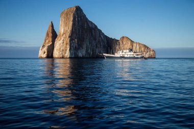 A cruise ship and rock formation in the Galapagos Islands