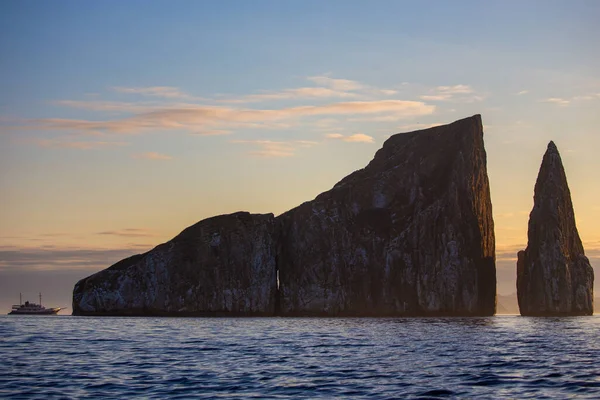 A cruise ship and rock formation in the Galapagos Islands