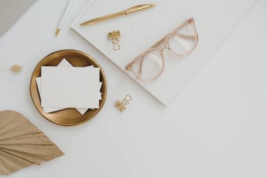 Aesthetic luxury bohemian branding or invitation card template. Blank paper invitation card sheet with empty mock up copy space, glasses, album on white background