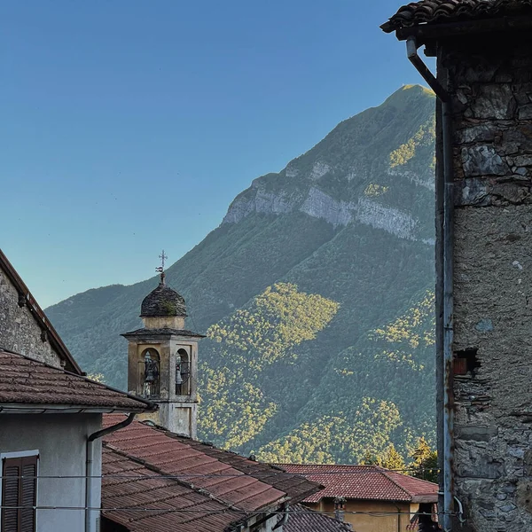 Ancient Italian architecture. Italian village in mountains with chapel, traditional buildings, wooden windows. Aesthetic summer vacation travel concept