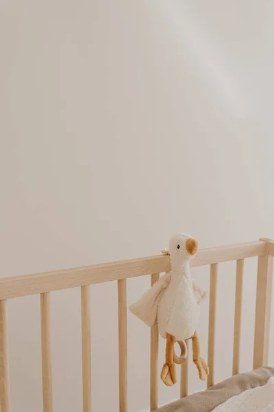 Children\'s toy duck on crib. Baby minimal interior design decoration