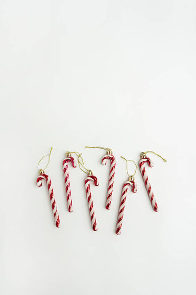 Christmas tree decoration. Toy candy canes on white background. Minimal Christmas holidays concept. Flat lay, top view