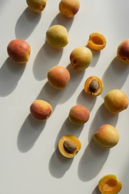 Tarafsız bej arka planda güneş ışığı gölgeli taze şeftali deseni.