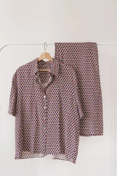 Beyaz arkaplanda asılı mor pijamalar