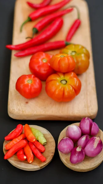 Indonesian chili sauce ingredients. Red chili, shallot, heirloom or hillbilly tomato, red hot chili pepper.