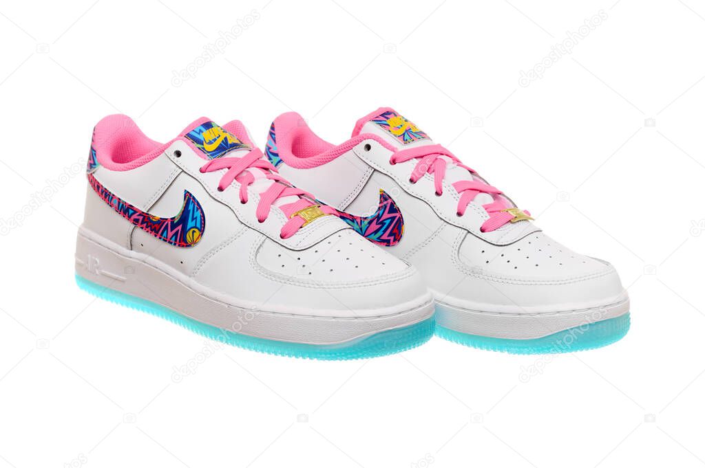 Ukraine, Ivano-Frankivsk - 01.05.2023. Editorial. Nike AIR FORCE 1 GS DZ4883-100. Colourful pair of sneakers. White shoes with particoloured inserts and pink laces.