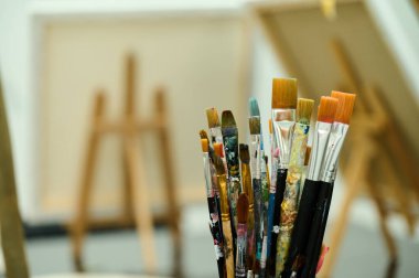 Arkasında sehpa olan boya fırçaları.