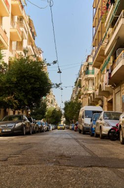 Parking space problem in a beautiful, narrow street in Athens, Vertical